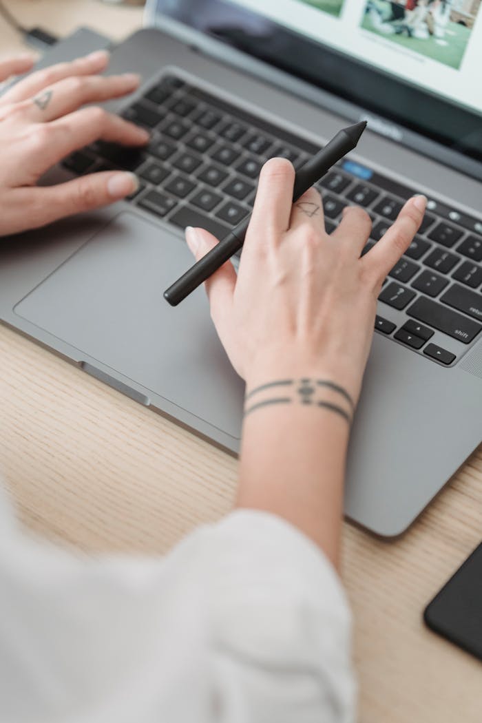 Crop anonymous woman working on laptop
